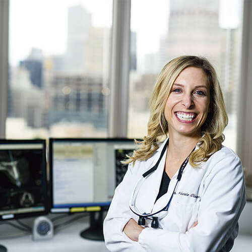 doctor smiling in front of window